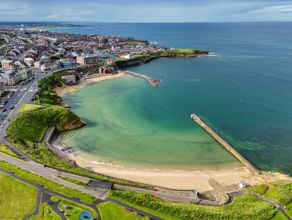 Aerial image of Cullercoats Bay along the North East Coast between Tynemouth and Whitley Bay. Northumberland. United Kingdom. 7th July 202